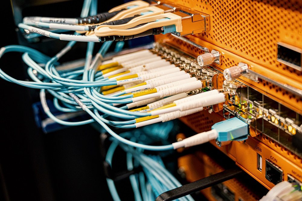 Fibre patch cords terminated into a rack-mounted network switch.